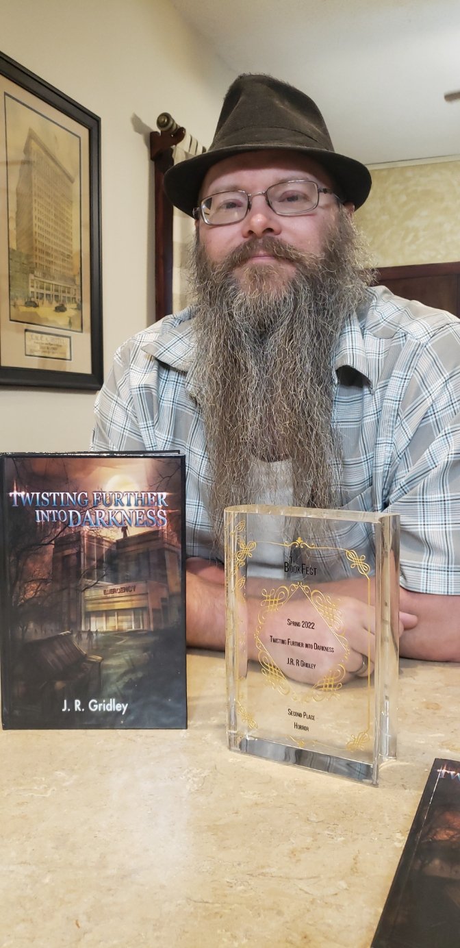 J.R. Gridley with Twisting Further into Darkness and his BookFest award